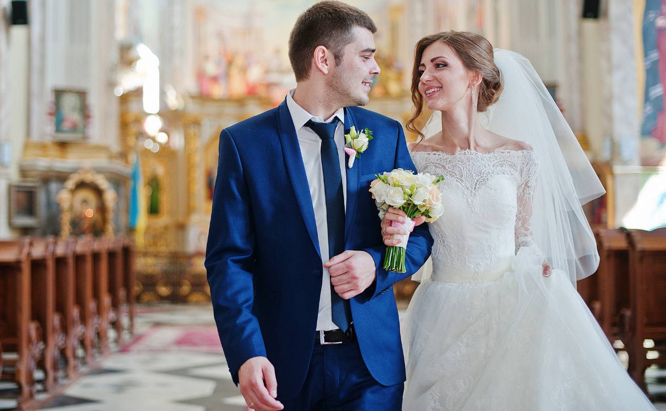 married couple walking out from the church